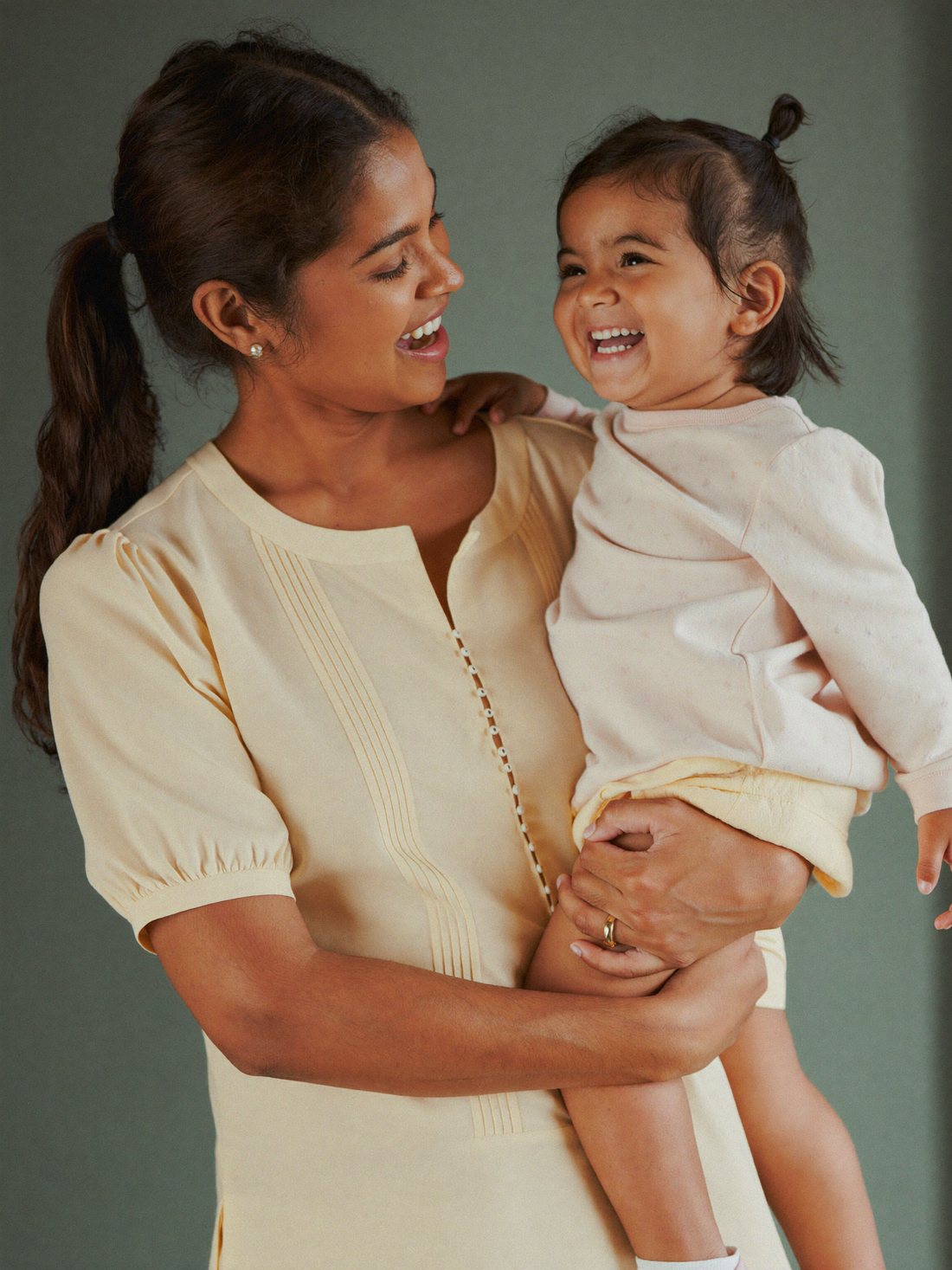 Mother and healthy laughing toddler at a paediatric clinic in Bangalore